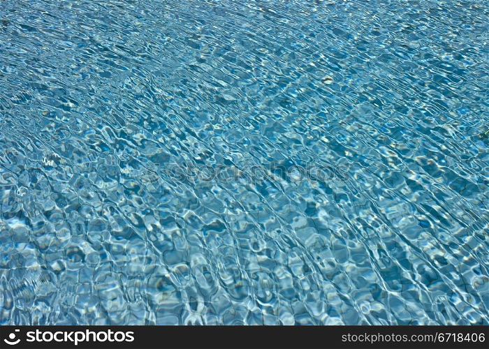 The Most beautiful clear pool water reflecting in the sun