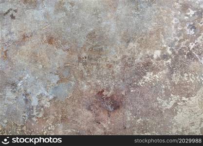 The mottled texture of canvas and old plaster in beige, brown and gray tones as part of a classic design in a retro style.. Abstract spotted pattern on the wall with the texture of old plaster in gray, green and brown colors in a retro style.