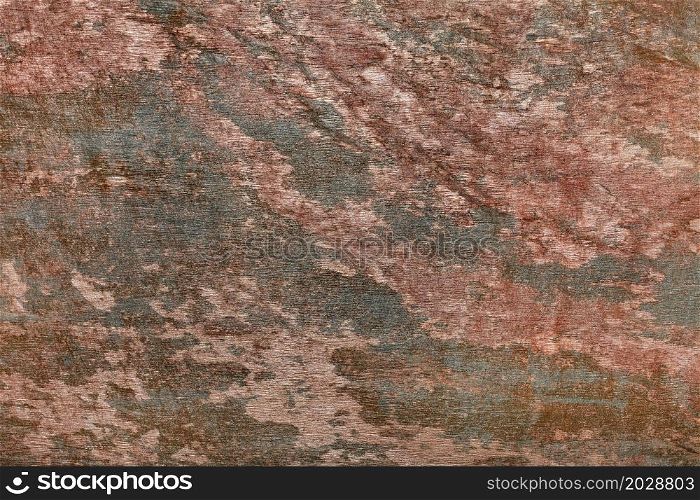 The mottled texture of stucco in browns and greens as part of a classic design.. Abstract spotted pattern on the wall with the texture of brown and green plaster in dark colors.