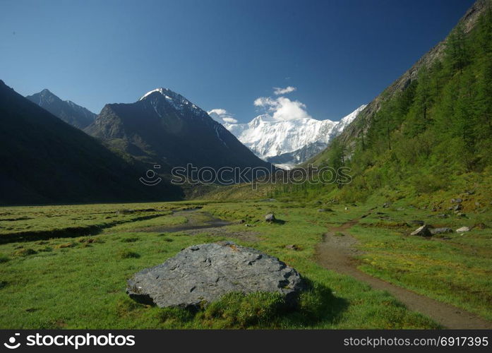 The mountain river in the mountains. Current through the gorge the river. Stones and rocky land near the river. Beautiful mountain landscape. The mountain river in the mountains. Current through the gorge the river. Stones and rocky land near the river. Beautiful mountain landscape.