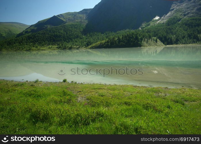 The mountain river in the mountains. Current through the gorge the river. Stones and rocky land near the river. Beautiful mountain landscape. The mountain river in the mountains. Current through the gorge the river. Stones and rocky land near the river. Beautiful mountain landscape.