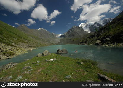 The mountain river in the mountains. Current through the gorge the river. Stones and rocky land near the river. Beautiful mountain landscape. The mountain river in the mountains. Current through the gorge the river. Stones and rocky land near the river. Beautiful mountain landscape.