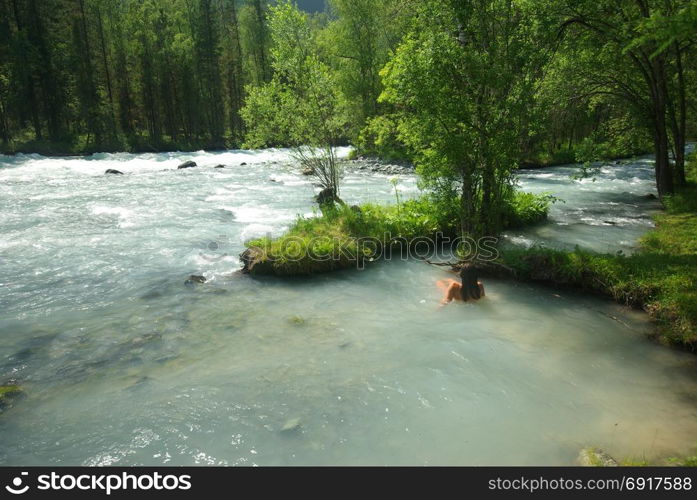 The mountain river in the mountains. Current through the gorge the river. Stones and rocky land near the river. Beautiful mountain landscape. The mountain river in the mountains. Current through the gorge the river. Stones and rocky land near the river. Beautiful mountain landscape.