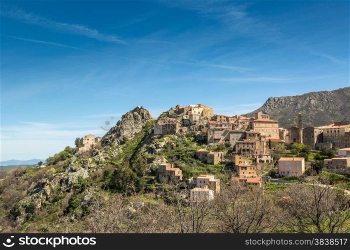 The mountain village of Speloncato in the Balagne region of north Corsica against a blue sky and wispy clouds