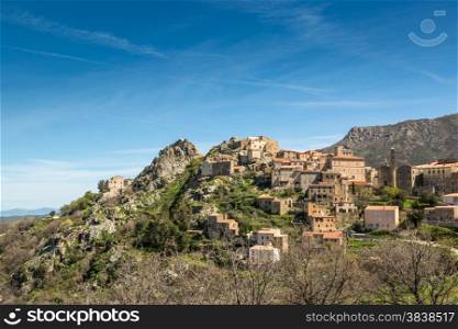 The mountain village of Speloncato in the Balagne region of north Corsica against a blue sky and wispy clouds