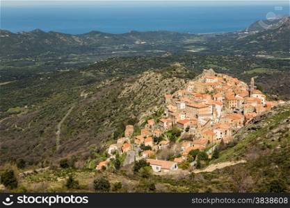 The mountain village of Speloncato in the Balagne region of north Corsica with maquis and the Mediterranean in the background