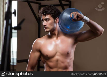 The muscular ripped man with big water bottle. Muscular ripped man with big water bottle