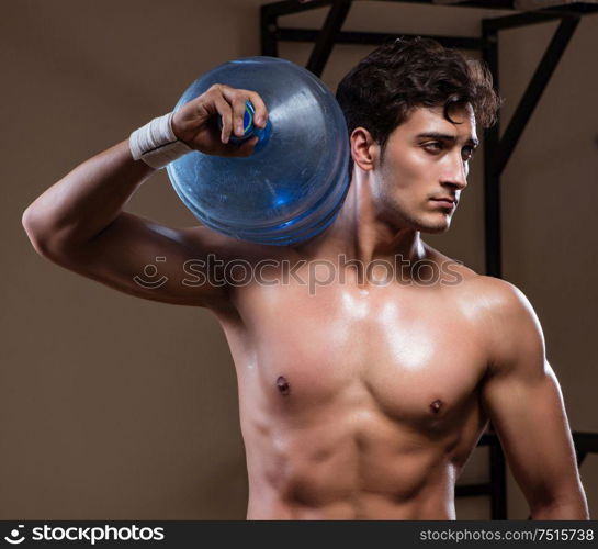 The muscular ripped man with big water bottle. Muscular ripped man with big water bottle