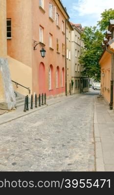 The narrow old street with lanterns in a historical part of the old city. Warsaw. Poland.. Warsaw. The narrow old street.
