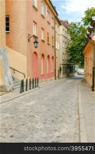 The narrow old street with lanterns in a historical part of the old city. Warsaw. Poland.. Warsaw. The narrow old street.