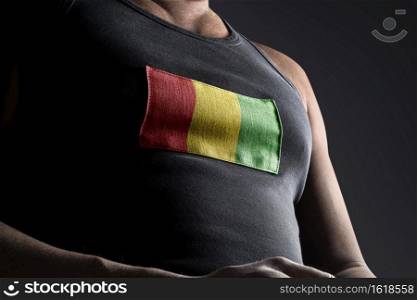 The national flag of Guinea on the athlete’s chest.. The national flag of Guinea on the athlete’s chest
