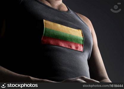 The national flag of Lithuania on the athlete’s chest.. The national flag of Lithuania on the athlete’s chest