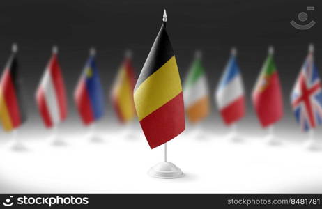 The national flag of the Belgium on the background of flags of other countries.. The national flag of the Belgium on the background of flags of other countries