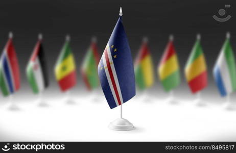 The national flag of the Cape Verde on the background of flags of other countries.. The national flag of the Cape Verde on the background of flags of other countries