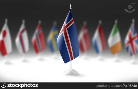 The national flag of the Iceland on the background of flags of other countries.. The national flag of the Iceland on the background of flags of other countries