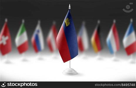 The national flag of the Liechtenstein on the background of flags of other countries.. The national flag of the Liechtenstein on the background of flags of other countries