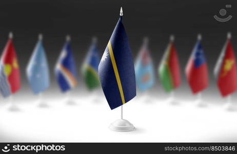 The national flag of the Nauru on the background of flags of other countries.. The national flag of the Nauru on the background of flags of other countries