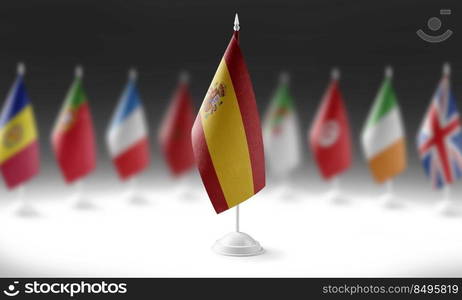 The national flag of the Spain on the background of flags of other countries.. The national flag of the Spain on the background of flags of other countries