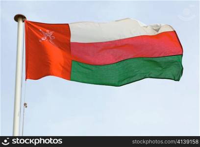 The national flag of the Sultanate of Oman in the south of Arabia