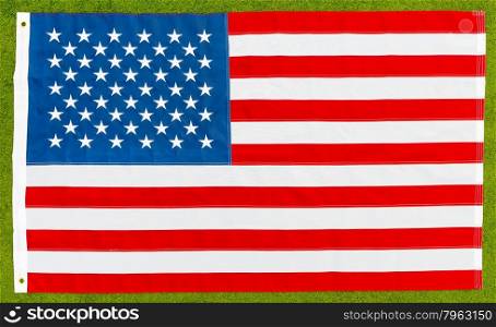 the national flag of the United States lying on the lawn