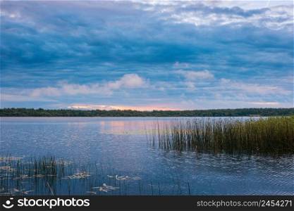 The nature of Belarus, a serene summer morning, a bright dawn on Lake Selyava. Landscape on the lake