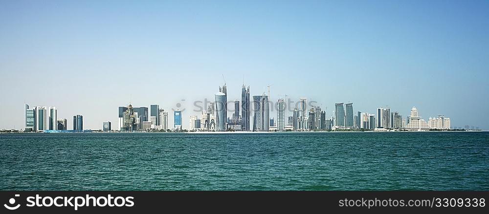 The new skyline of the Qatari capital city, Doha, seen from close to the harbour around which the original city arose.