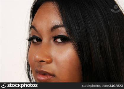 The nice face of an young Asian woman in close up with black hair.