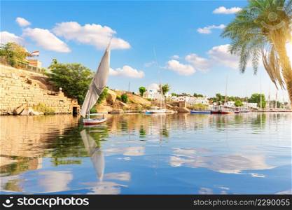 The Nile view, sailboat and banks of Aswan, Egypt.