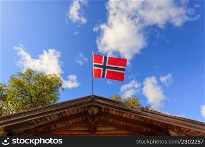 The norwegian flag waving against blue sky. The norwegian flag against blue sky