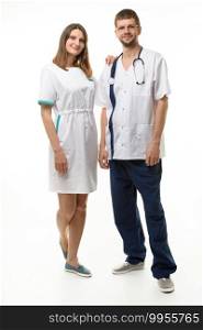 the nurse put her hand on the doctor’s shoulder, both happily look into the frame, full length