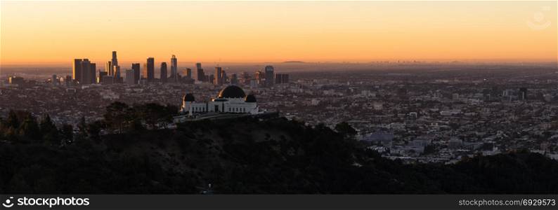 The obseratory dominates the forground with the city skyline of Los Angeles in the background