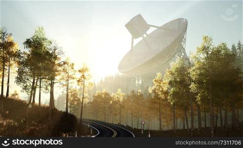 The observatory radio telescope in forest at sunset