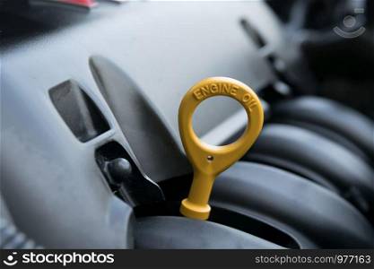 The oil dipstick of a car engine