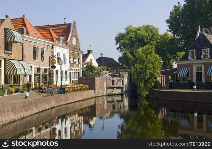 The old 16th century (1571) village of Spaarndam, the Netherlands, with the old inner harbour, it&rsquo;s sluices and locks, the fishermans&rsquo; houses, currently a quaint town with a terrace, bikes and a very quiet atmosphere