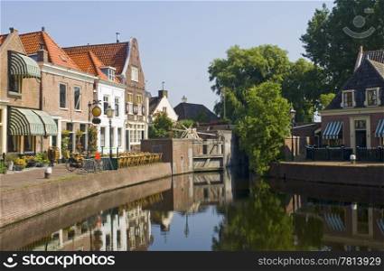 The old 16th century (1571) village of Spaarndam, the Netherlands, with the old inner harbour, it&rsquo;s sluices and locks, the fishermans&rsquo; houses, currently a quaint town with a terrace, bikes and a very quiet atmosphere