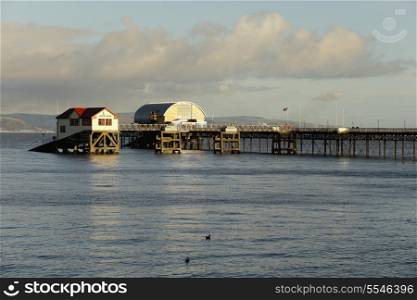 The old and new Royal National Lifeboat Institute boatsheds at the end of Mumbles Pier, Swansea Bay, December 2013