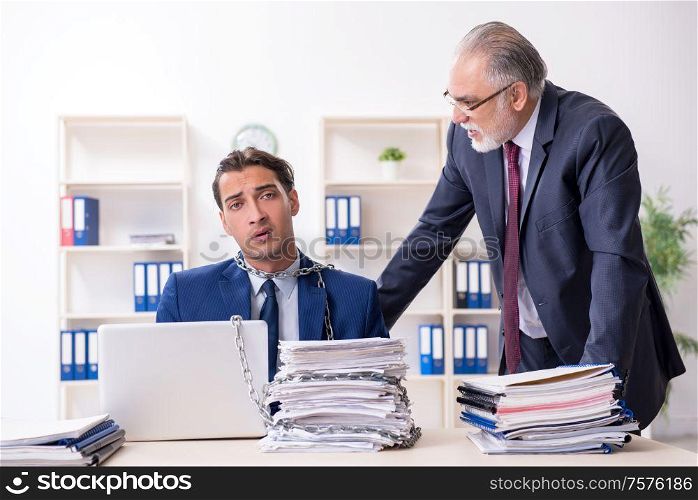 The old boss and young male employee in the office. Old boss and young male employee in the office