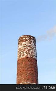 The old brick wall of the building, which is heated with coal and wood to produce heat and heat other buildings. Brick pipe sky