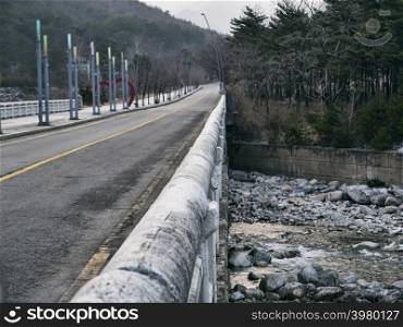 The old bridge under the mountain river. Sokcho city, South Korea