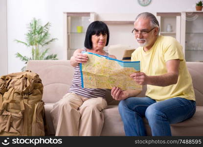 The old couple preparing for vacation travel. Old couple preparing for vacation travel