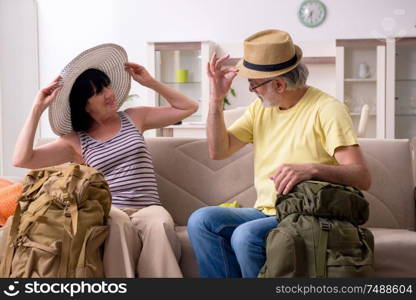 The old couple preparing for vacation travel. Old couple preparing for vacation travel