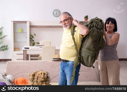 The old couple preparing for vacation travel. Old couple preparing for vacation travel