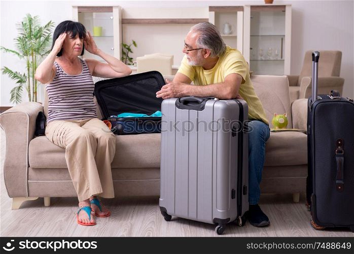 The old couple preparing for vacation travel. Old couple preparing for vacation travel