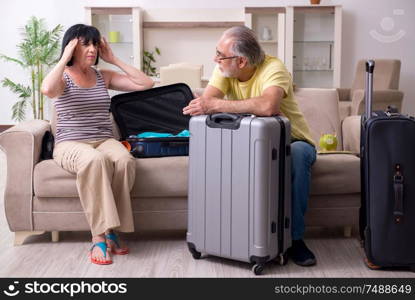 The old couple preparing for vacation travel. Old couple preparing for vacation travel