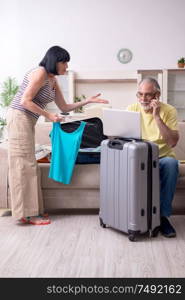 The old couple preparing for vacation travel. Old couple preparing for vacation travel