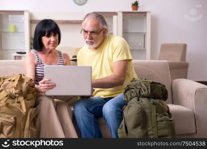 The old couple preparing for vacation travel. Old couple preparing for vacation travel