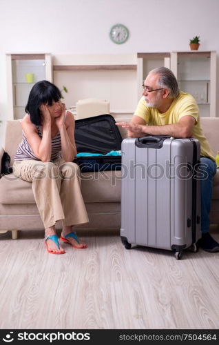 The old couple preparing for vacation travel. Old couple preparing for vacation travel