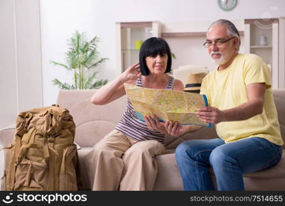 The old couple preparing for vacation travel. Old couple preparing for vacation travel