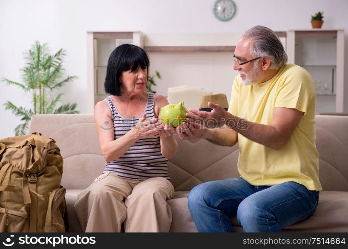 The old couple preparing for vacation travel. Old couple preparing for vacation travel