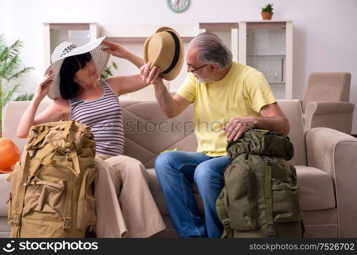 The old couple preparing for vacation travel. Old couple preparing for vacation travel